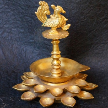 Traditional brass deepas with peacock on top